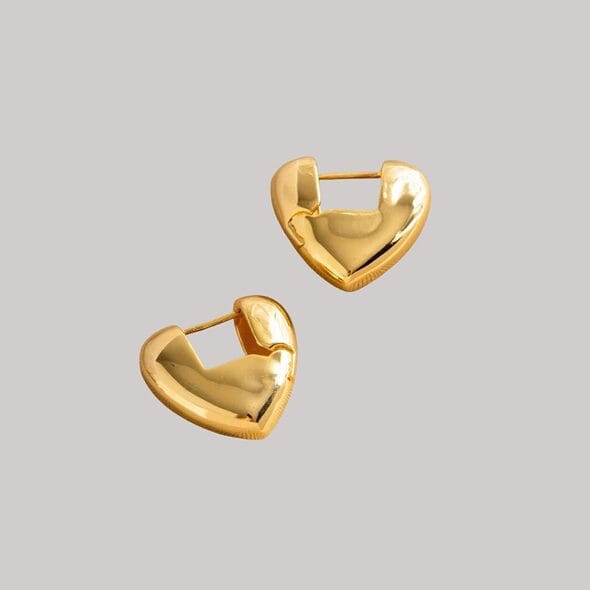 Fall in love with the Golden Heart Glow Earrings – beautifully crafted heart-shaped earrings with a sleek, polished gold finish. These hypoallergenic earrings are made with premium materials and plated in 18k gold, ensuring both style and comfort. Free from nickel, lead, and cadmium, they’re safe for sensitive skin and ideal for women who appreciate romantic, elegant, and timeless jewelry. Whether for everyday wear or special occasions, these earrings add a graceful touch to any outfit. Shop now at Madu Joia Rara and shine with love.