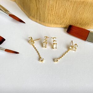 Gold duo earring set featuring zirconia stones, including a delicate chain drop and classic stud design. Hypoallergenic semi-jewelry plated in 18k gold.