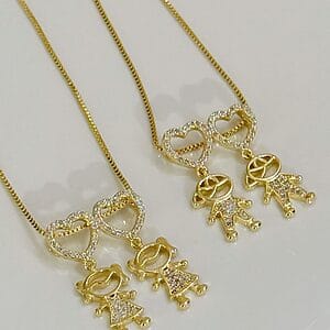 Gold heart pendant necklace with boy and girl charms, hypoallergenic semi-jewelry made with premium materials, featuring zirconia stones and 18k gold plating.