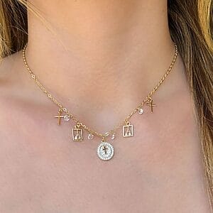 Gold Religious Charm Necklace with crosses, Our Lady pendants, and zirconia accents. Hypoallergenic semi-jewelry plated in 18k gold for lasting shine.