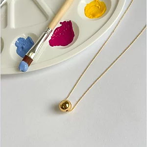 Minimalist necklace with a polished gold sphere on a fine chain, 18k gold plated.
