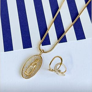 Golden Faith Pendant & Pavé Ring Set featuring 18k gold-plated oval religious pendant with pavé zirconia and matching intertwined pavé ring