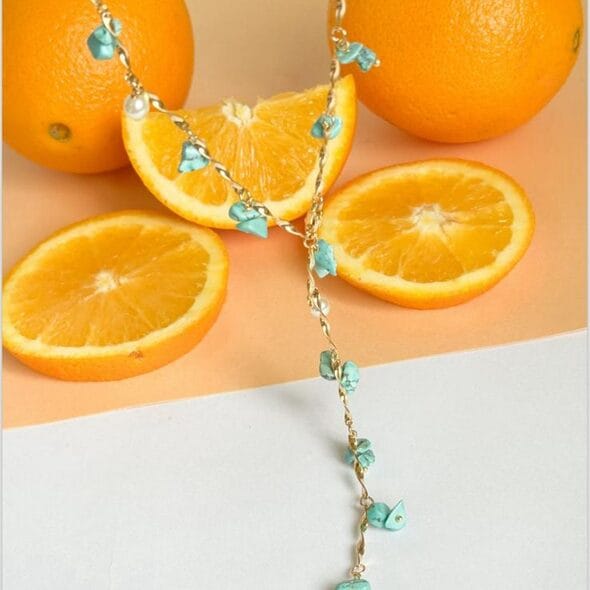 Turquoise And Pearl Drop Necklace is a Gold chain necklace with turquoise chips and pearl drops, handcrafted boho-chic design