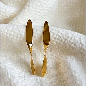 Twist Ribbon Drop Earrings Long sculptural gold drop earrings with a subtle ribbon twist, 18k gold plated.