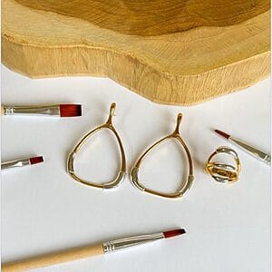 Two‑tone open teardrop earrings with silver accents and a matching sculptural ring, 18k gold plated