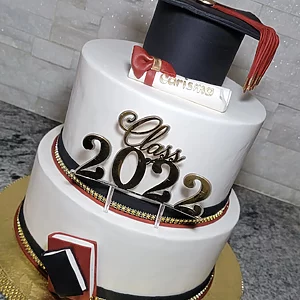 “Elegant graduation cake decorated with school colors and graduation topper from Karamelado Cakes & Pastries in Clearwater.”