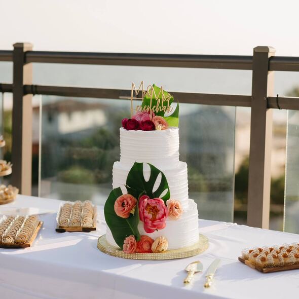 Custom wedding cake with elegant, handcrafted decorations from Karamelado Cakes & Pastries in Clearwater