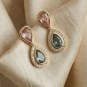“Gold earrings featuring two teardrop crystals in rosé and deep blue, with the lower drop surrounded by micro-crystals.”