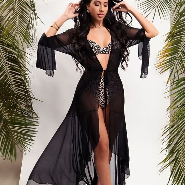 Long black sheer beach cover‑up with flowing silhouette by Fashion Brasil Sun and Sea, Brazilian resort wear.