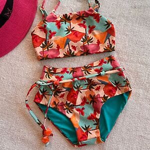 Kids’ bikini with colorful tropical print, designed for comfort and play at the beach.