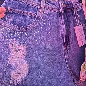 Distressed denim shorts with stud details and frayed hem by Fashion Brasil Sun and Sea.