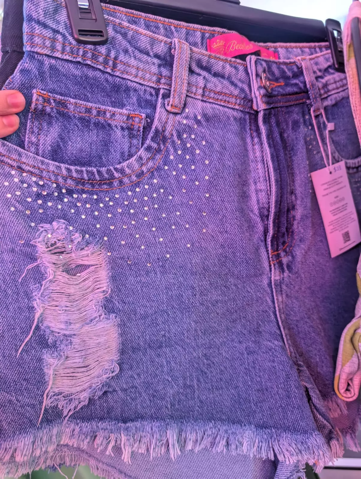 Distressed denim shorts with stud details and frayed hem by Fashion Brasil Sun and Sea.