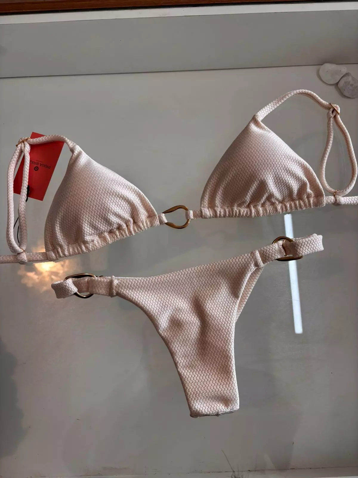 Textured sand‑tone two‑piece bikini with triangle top and side ring details, Fashion Brasil Sun and Sea.