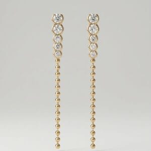 Golden Cascade drop earrings by Madu Joia Rara featuring round brilliant stones and a long gold beaded chain with elegant movement