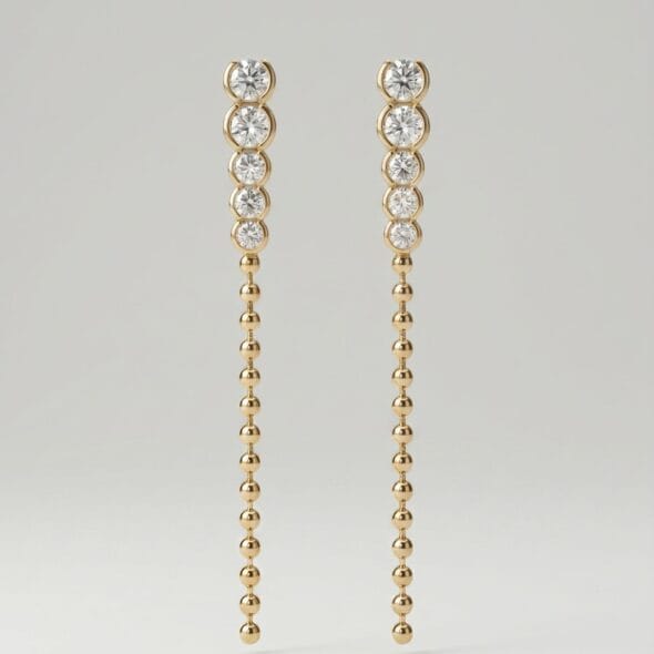 Golden Cascade drop earrings by Madu Joia Rara featuring round brilliant stones and a long gold beaded chain with elegant movement