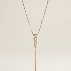Golden Grace Y‑necklace by Madu Joia Rara featuring brilliant round stones and a delicate gold beaded drop with elegant vertical design