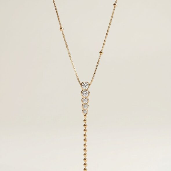 Golden Grace Y‑necklace by Madu Joia Rara featuring brilliant round stones and a delicate gold beaded drop with elegant vertical design