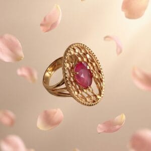 Gold ring with pink sapphire center stone surrounded by delicate details, symbolizing love and a meaningful Mother’s Day jewelry gift.