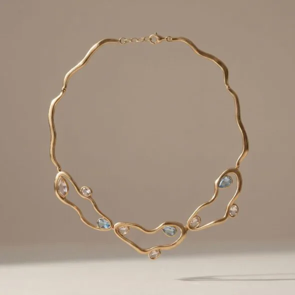 Gold diamond-style necklace with high-shine stones displayed on a soft neutral background, a luxurious Mother’s Day gift by Madu Joia Rara.
