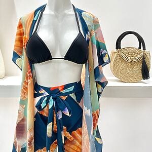 Tropical two‑piece pareo set with printed beach cover‑up and matching bikini top, Fashion Brasil Sun and Sea.