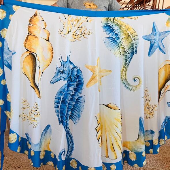 Tropical two‑piece pareo set with printed beach cover‑up and matching bikini top, Fashion Brasil Sun and Sea.