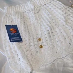 White crochet beach shorts with drawstring waist and gold detail, lightweight and breathable, Fashion Brasil Sun and Sea.
