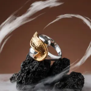 Golden Wave Ring by Madu Joia Rara featuring a textured gold wave design on a polished silver-tone band.