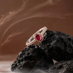 Ruby Glow Ring by Madu Joia Rara featuring a ruby-red oval gemstone surrounded by sparkling crystal accents.