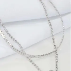 Black Teardrop Double Layer Necklace by Mari Semijoias featuring layered silver-tone chains and polished black teardrop pendant
