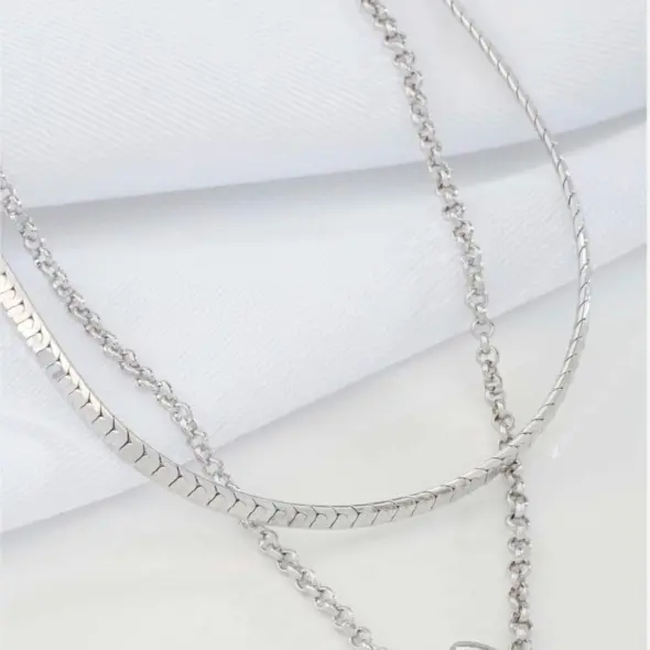 Black Teardrop Double Layer Necklace by Mari Semijoias featuring layered silver-tone chains and polished black teardrop pendant