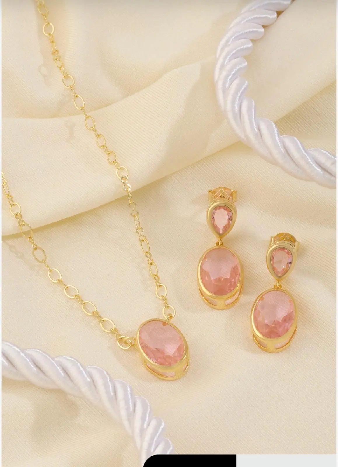 gold pink jewelry set mari semijoias lifestyle | Pink Oval Jewelry Set - Mari Semijoias Pink Oval Jewelry Set by Mari Semijoias featuring a gold-tone necklace and matching earrings with blush pink oval stones