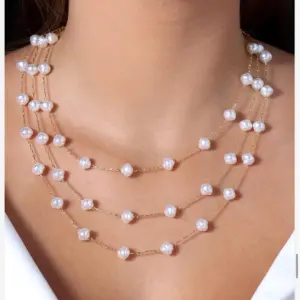 Mari Semijoias Baroque Pearl Layers Necklace with three strands of freshwater pearls and gold-tone chain
