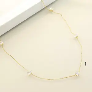 Mari Semijoias Golden Hearts Necklace with delicate gold chain and heart-shaped zirconia accents