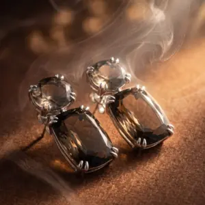 Quartz Elegance Earrings Elegant drop earrings featuring faceted quartz-inspired stones in warm brown tones, set in a polished silver-tone finish and displayed on a luxurious golden background, showcasing timeless sophistication by Madu Joia Rara.
